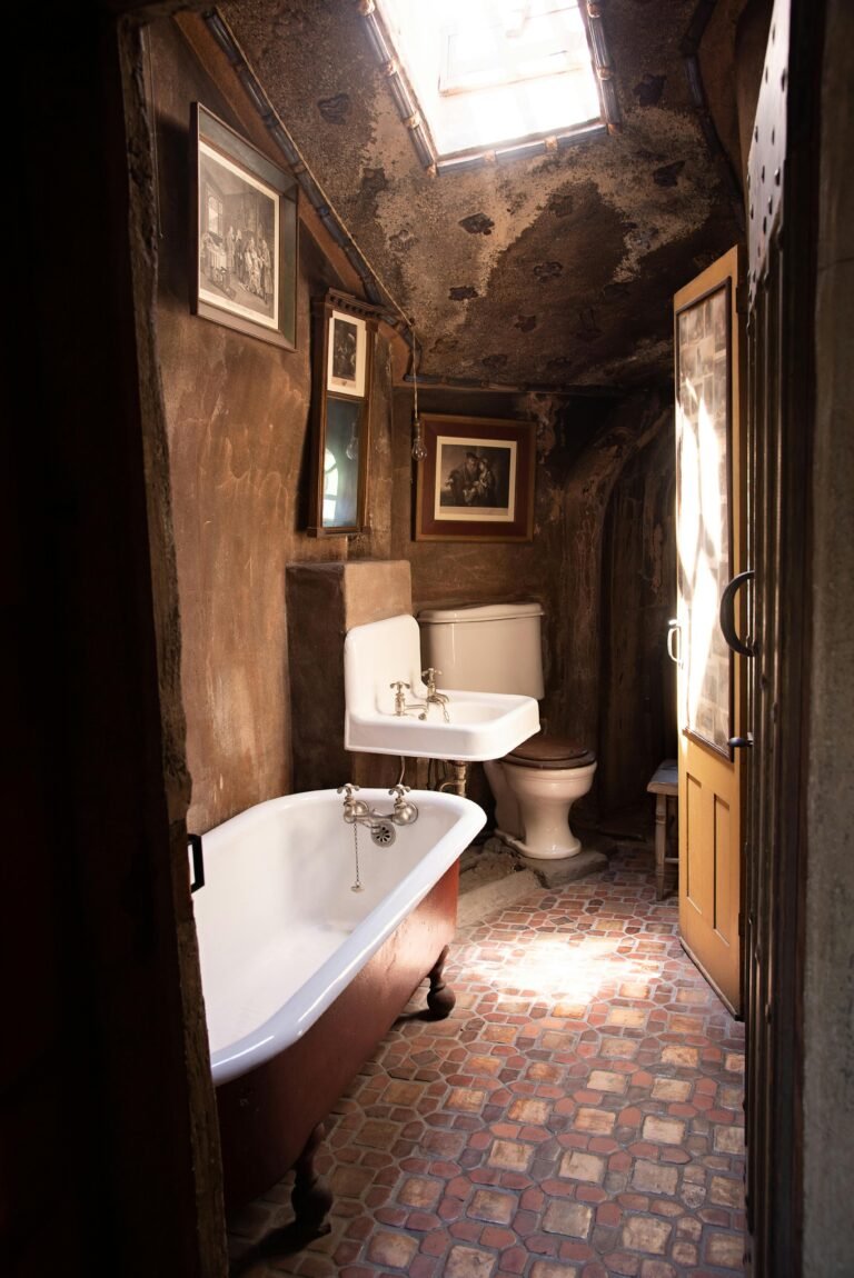 Explore this charming vintage bathroom featuring an antique clawfoot tub and rustic interior design.