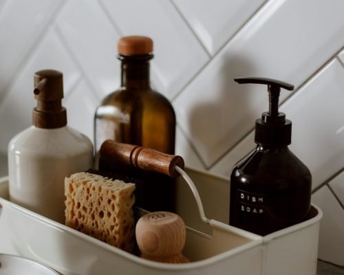 Close-up of chic kitchen cleaning essentials on a stylish countertop.